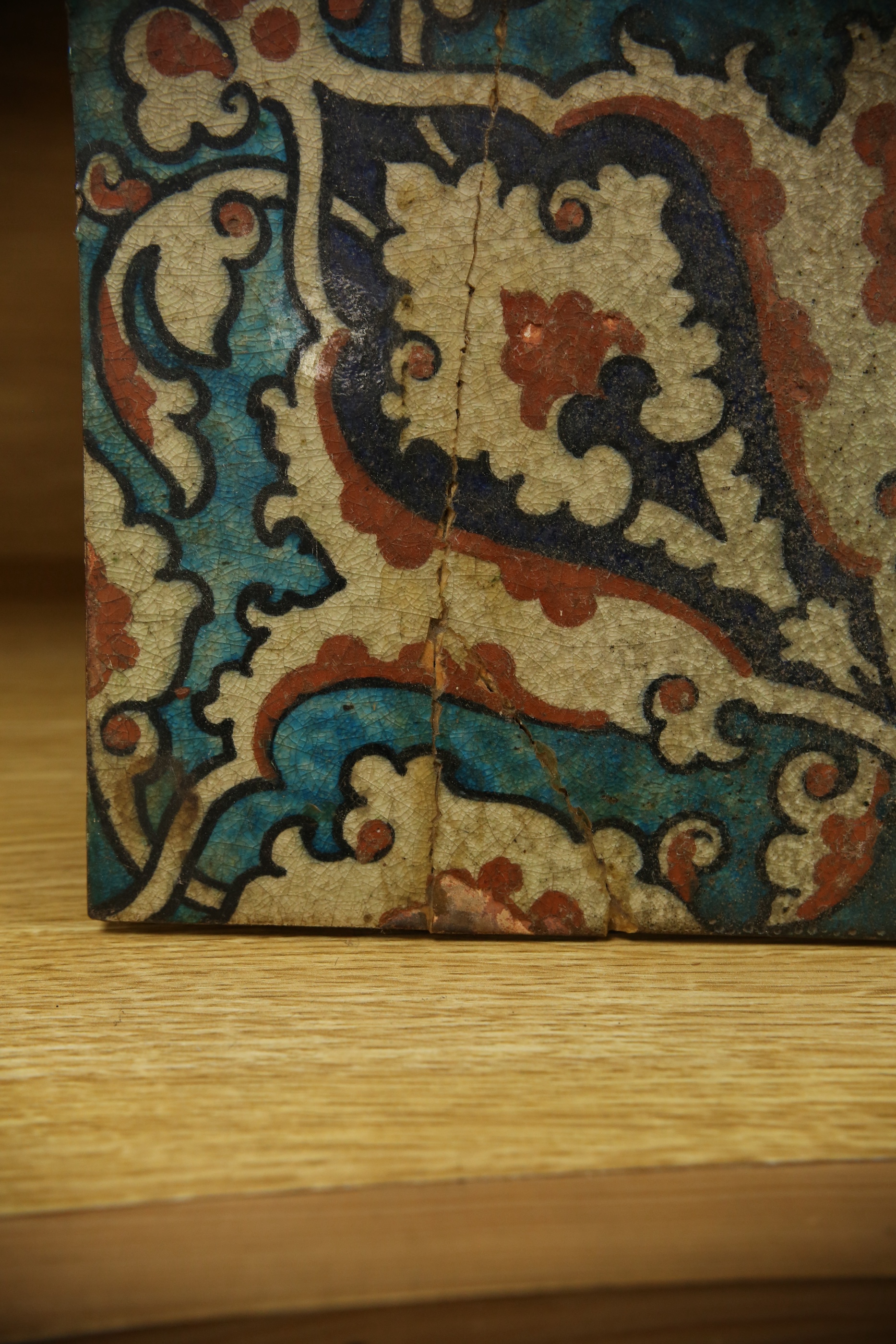 A 17th century style Iznik pottery tile, 20.5cm sq. Condition - poor